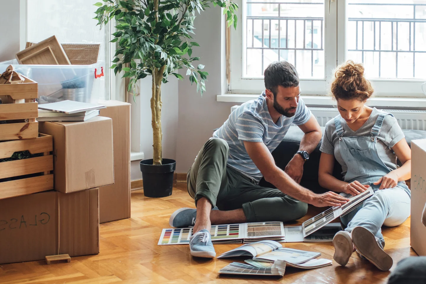 Man en vrouw zoeken kleurstalen uit voor hun nieuwe huis